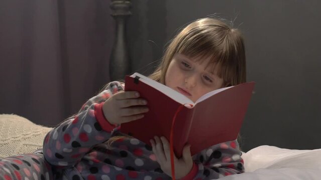 Child reading a book. Immersion into the magical world