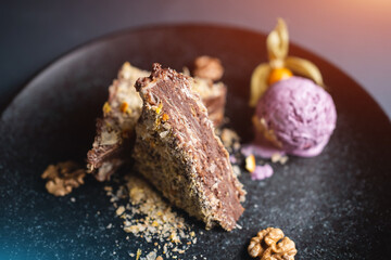 puff cake with chocolate custard, walnut and blueberry ice cream on black plate