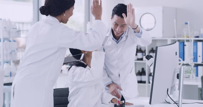 Team of scientists celebrating with high five gesture after genetic breakthrough in monkeypox cure. Diverse group of pathologist and biochemical engineers using computer and microscope in laboratory