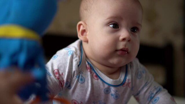 Newborn Active Baby Cute Smiling Teethless Face Portrait Early Days On Stomach Developing Neck Control. 5 Months Child In Playpen Gnaws Toys Look At Camera. Infant, Childbirth, Beginning Concept