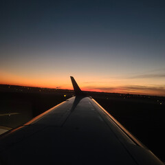 Fototapeta premium airplane landing at sunset