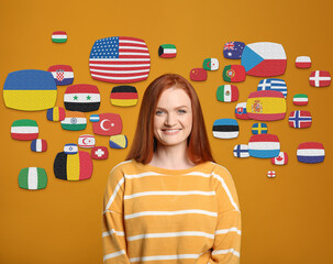 Portrait of interpreter and flags of different countries on yellow background