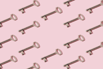Metal key on a pink background. Pattern. Copy space.