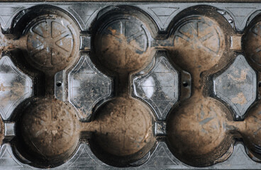 Plastic black round trays, cells for pots close-up. Photography, top view, background.
