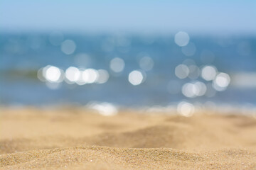 Fototapeta na wymiar Sandy beach near sea on sunny day, closeup view