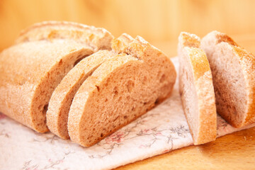 Tasty backed bread with slices on the table, wheat food