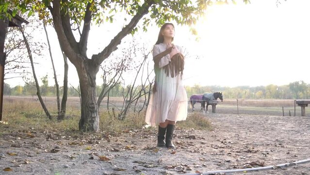 Slow Motion Young beautiful girl with a horse on the dry field