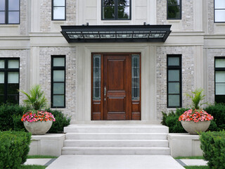 Fototapeta na wymiar House entrance with elegant wood grain front door with sidelights