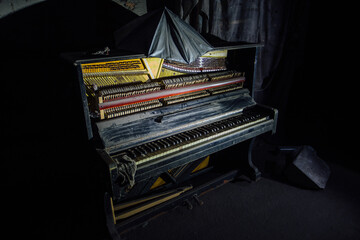 Old broken piano in dark room