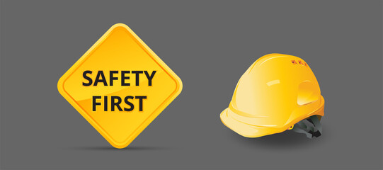 Safety first sign on background, construction concept, Yellow safety hard hat