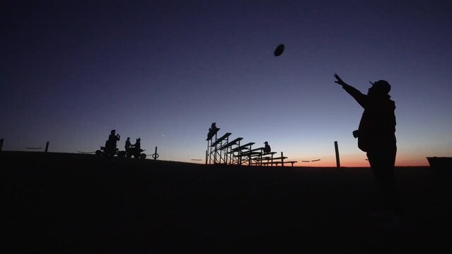 silhouette of a people flaying football 