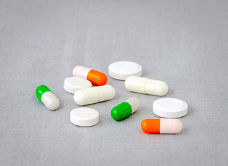 Medication: capsules and pills on a gray background. Medical concept. Close-up