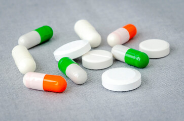 Medication: capsules and pills on a gray background. Medical concept. Close-up