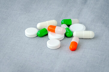 Medication: capsules and pills on a gray background. Medical concept. Close-up