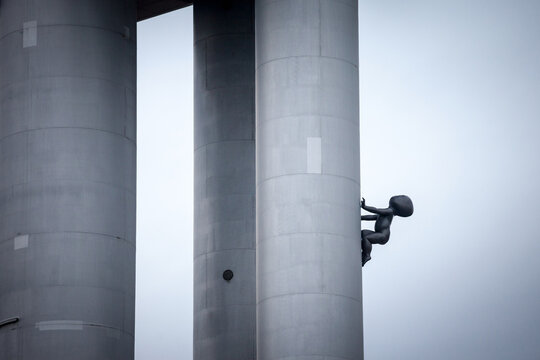 PRAGUE, CZECHIA - NOVEMBER 1, 2019: Sculpture of a bronze faceless baby crawling the Zizkov Television Tower. Designed by Czech Artist David Cerny, these scultpure is called miminka