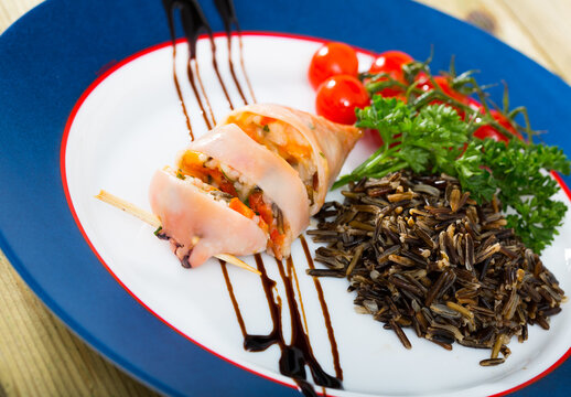 Stuffed squid with peppers, wild rice, eggs and herbs, top view..