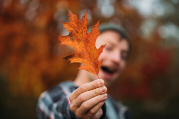 leaves in hand. Man autumn. Fashion photo. Happy day. Fun male. 