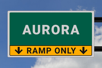Aurora logo. Aurora lettering on a road sign. Signpost at entrance to Aurora, USA. Green pointer in American style. Road sign in the United States of America. Sky in background