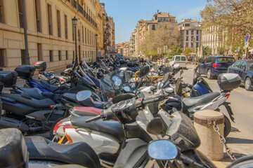 many motorcycles parking in a public square in Granada, Spain