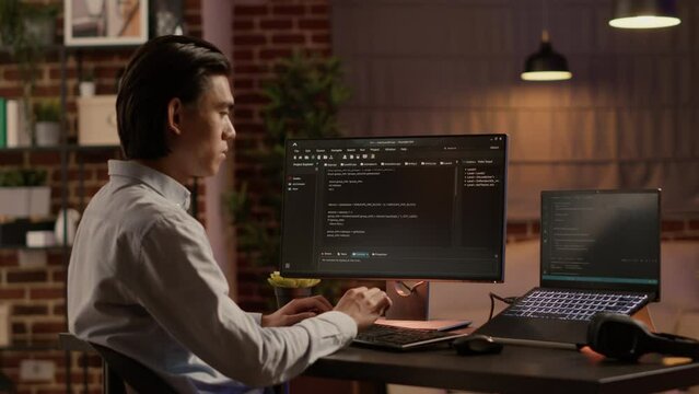 Asian programmer using binary code to script security system, programming firewall encryption. Working with data server to develop network on coding software, hacking application.