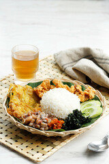 Nasi Campur Cumi Asin Surabaya, White Rice with Sautee Salted Squid, Sambal, Egg, and Boiled Cassava Leaf.