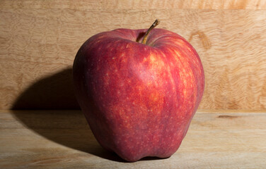Red Delicious apple. Delicious fruit on a wooden table.