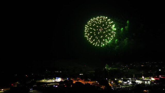An Aerial UAV Drone View of a Fireworks Display over a Small Hillside Community 