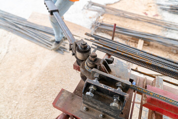 Worker using steel bending rebar self lever.