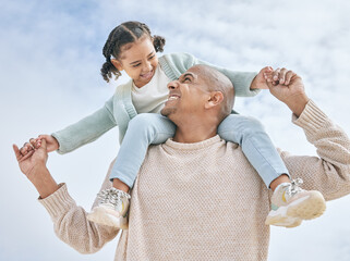 Smiling mixed race single father pretending to fly with little daughter at a beach with copyspace....