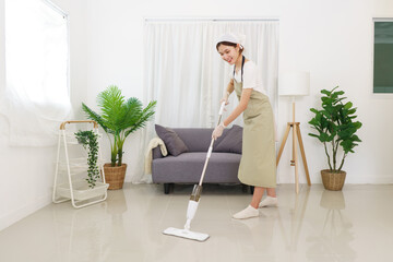 Lifestyle in living room concept, Young Asian woman cleaning the floor with vacuum cleaner