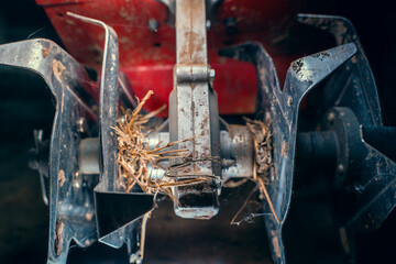 Nozzle cultivator on a small manual benzo walk-behind tractor close-up - obrazy, fototapety, plakaty