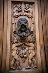 Fototapeta na wymiar Old wooden door texture with lock and knob. Door of ancient building in Toledo, Spain