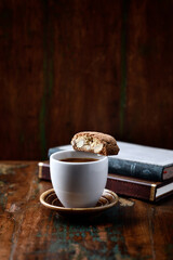 Cantuccini (Italian cookie) and a Cup of coffee on dark wooden background. Copy space