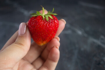 strawberry in hands
