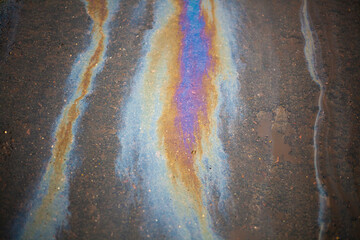Gasoline stain on asphalt. Spilled fuel.