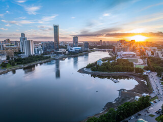 Fototapeta premium Yekaterinburg city and pond aerial panoramic view at summer sunset.