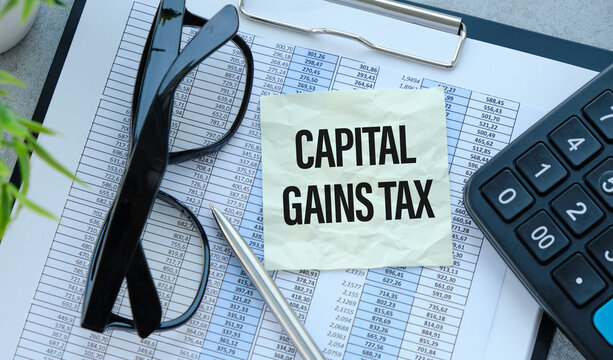 Capital gains tax-text label in the form of a document Registrar planning folder. Mandatory gratuitous payment is established by law by the state government