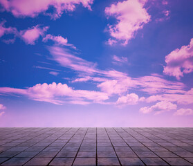 pink clouds, blue sky, gray floor.