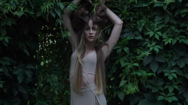 Slow Motion beautiful mystic elf in dress in woods
