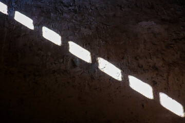 light shining through window on to interior wall