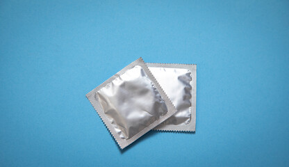 Condom on the blue background.