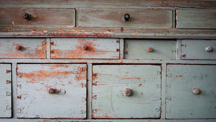 Old worn sideboard in light blue with many drawers and chipped paint. Copy space for your design. Web banner. 