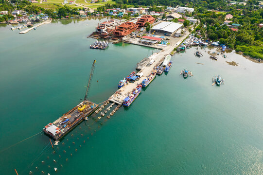 Sual, Pangasinan, Philippines - A fishing seaport under construction at the town of Sual. Josefa Slipways, and shipbuilding facility seen nearby.