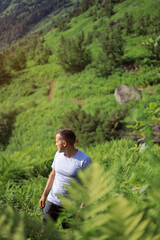 a man travels among the highlands covered with dense vegetation. Summer vacation and lifestyle concept