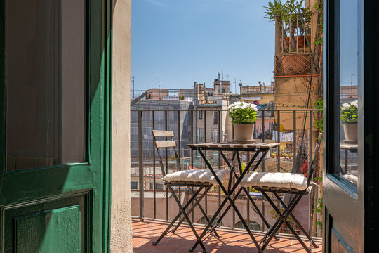 View Of Barcelona Through Open Wooden Shutters From Typical Spanish Old House With Beautiful Balcony