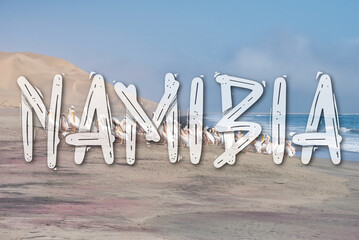 Big letters saying 'Namibia' in front of the coastline of Sandwich Harbour, Namibia. Travel...