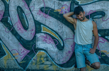 Young man portrait on graffiti grunge wall