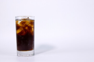 Fototapeta na wymiar A isolated glass of black cola with ice is filled on white background used in ads