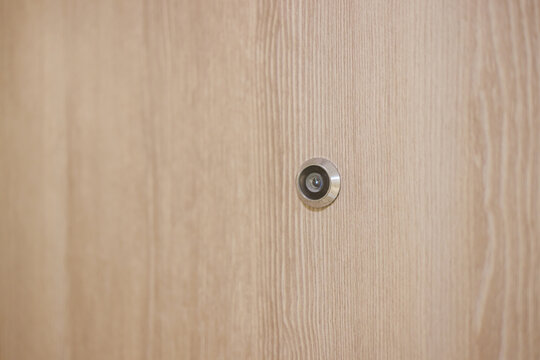 Door Lens Peephole On Wooden Background And Texture. Eyehole On Front Door Hotel.