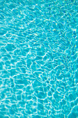 Fototapeta na wymiar blue swimming pool water background with ripples. summer resort